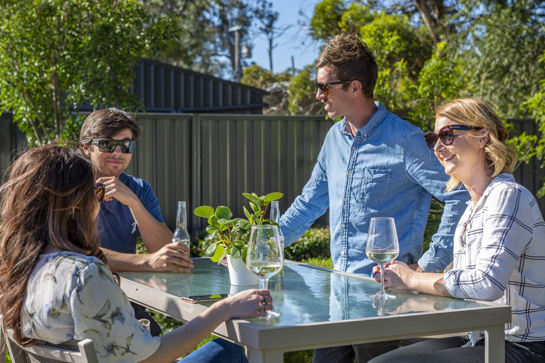 Outdoor gathering with privacy fence in background