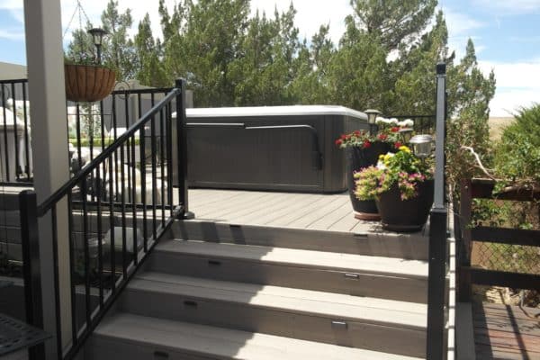 deck with ornamental railing and hot tub