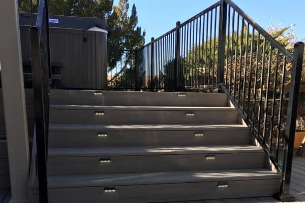 ornamental railing by stairs and hot tub